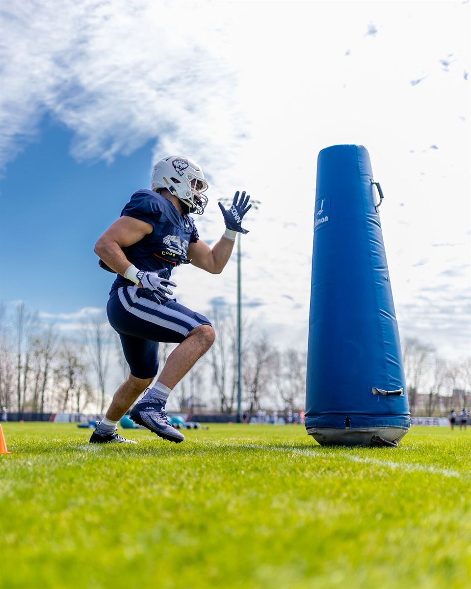 Pryce Yates working a pass-rush drill against a tackling dummy at UConn practice